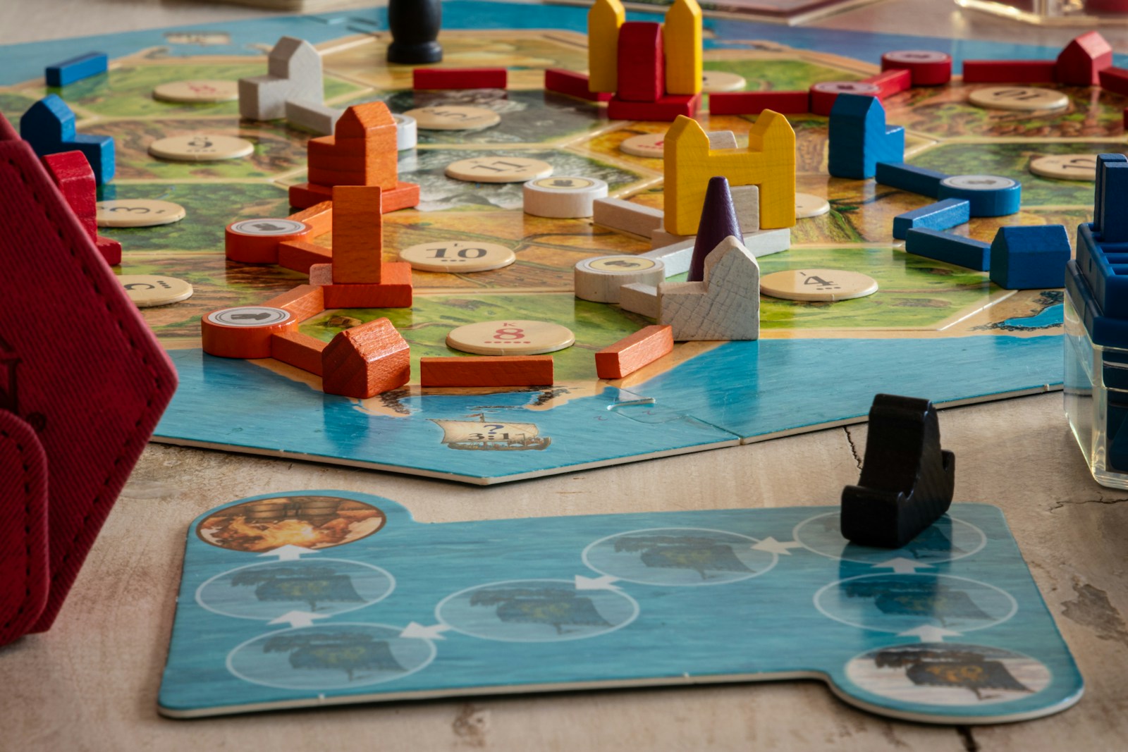 Wooden board-game components arranged on a table