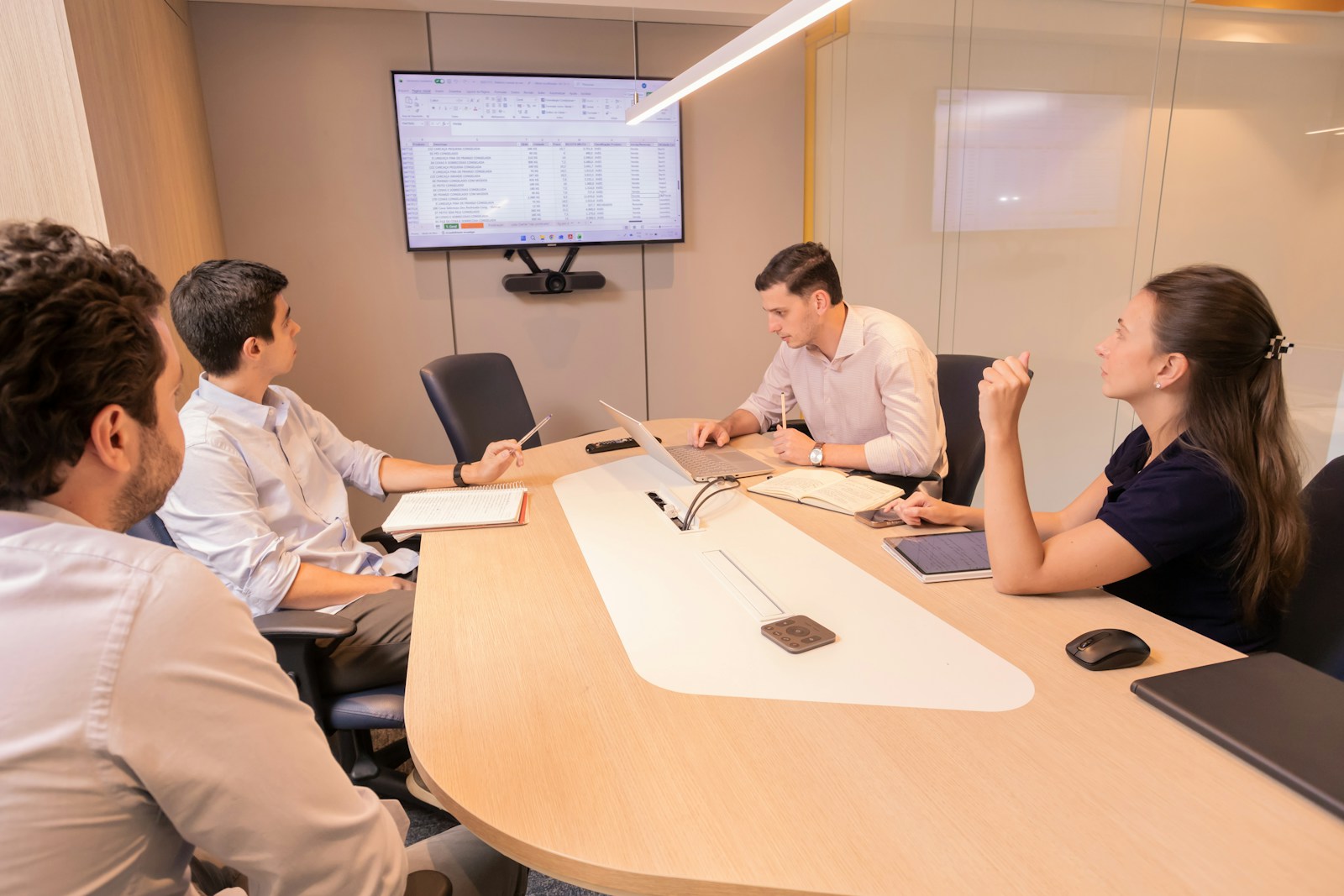 A team presenting and discussing a project around a table